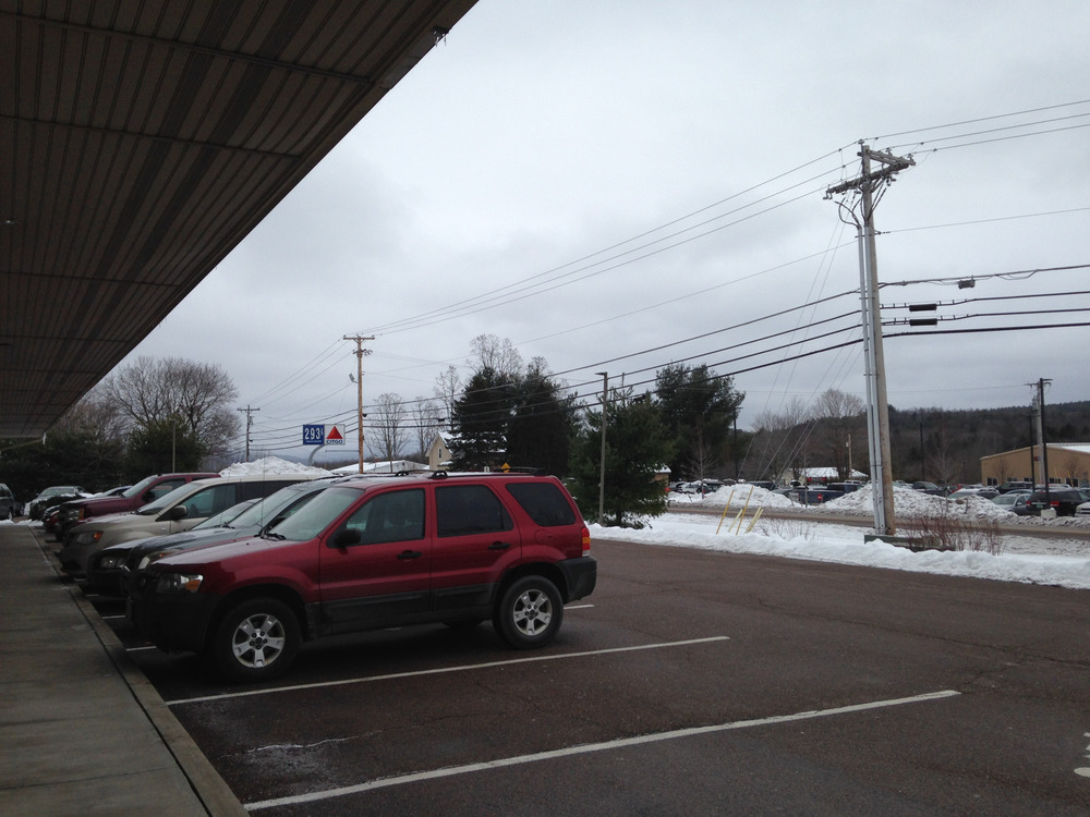 parking lot with gas sign in background