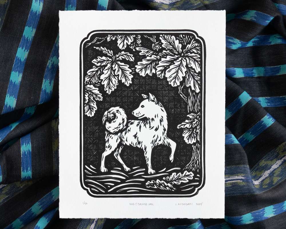 Black and white illustration of a dog under a daimyo oak tree. The white paper sits on top of rumpled blue striped fabric.