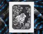 Black and white illustration of a sheep amogst hydrangea bushes. The white paper sits on top of rumpled blue striped fabric.